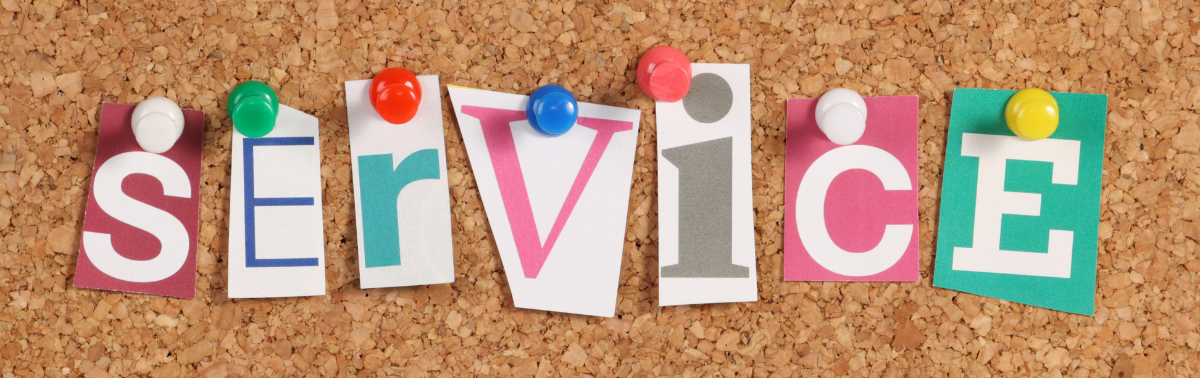 Image with letters pinned to a cork board that spell out "service"
